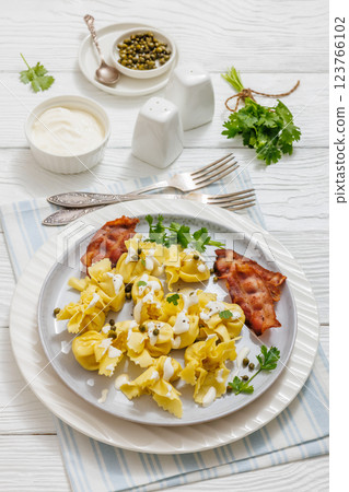sacchettoni, pasta with bacon and cheese filling sacchettoni, pasta with bacon and cheese filling 123766102