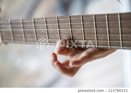 Child learning guitar chords Child learning guitar chords 123766331