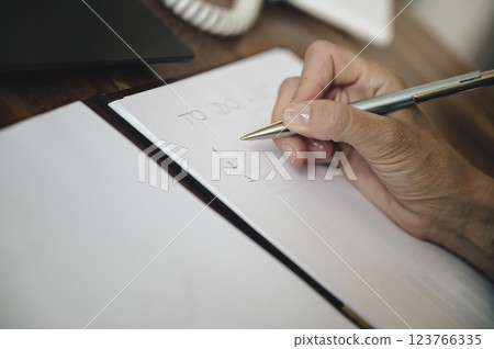 Closeup view of female hand writing a To do list 123766335