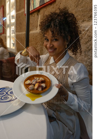 Girl with an octopus dish Girl with an octopus dish 123766395