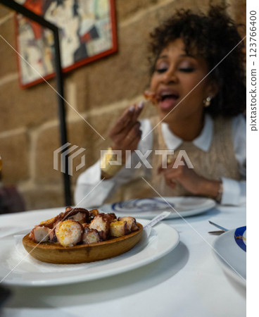 Girl with an octopus dish 123766400