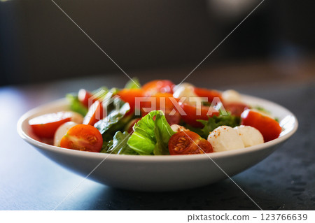 Salad with mozzarella balls tomatoes and mix salad 123766639
