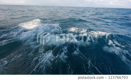 Side view from boat in Indian ocean sailing between Seychelles islands in daytime with big waves Side view from boat in Indian ocean sailing between Seychelles islands in daytime with big waves 123766703