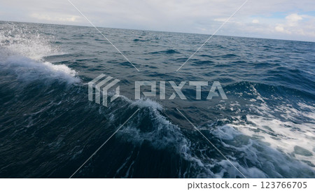 Side view from boat in Indian ocean sailing between Seychelles islands in daytime with big waves Side view from boat in Indian ocean sailing between Seychelles islands in daytime with big waves 123766705