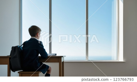 A contemplative child gazes out of the classroom window, lost in thought and wonderment A contemplative child gazes out of the classroom window, lost in thought and wonderment 123766793