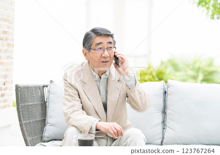 Senior man talking on a smartphone Senior man talking on a smartphone 123767264