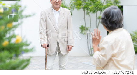 Senior couple walking with a cane 123767271