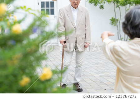 Senior couple walking with a cane 123767272