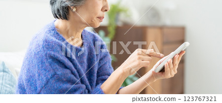 Senior woman operating a smartphone Senior woman operating a smartphone 123767321