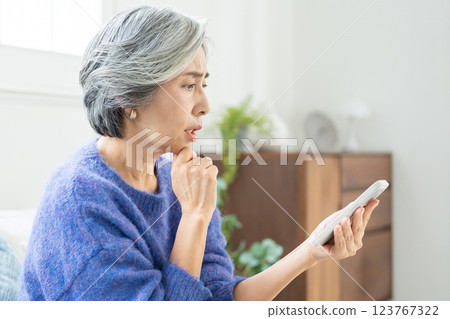 Senior woman operating a smartphone Senior woman operating a smartphone 123767322