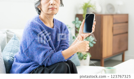 Senior woman operating a smartphone Senior woman operating a smartphone 123767325
