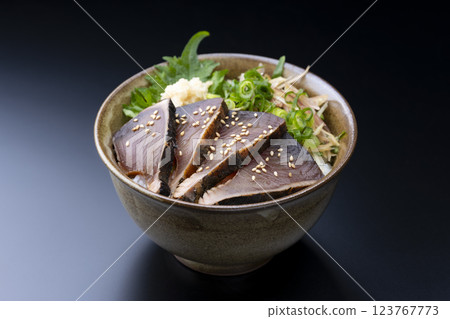 Seared bonito rice bowl with plenty of condiments on a black background Seared bonito rice bowl with plenty of condiments on a black background 123767773