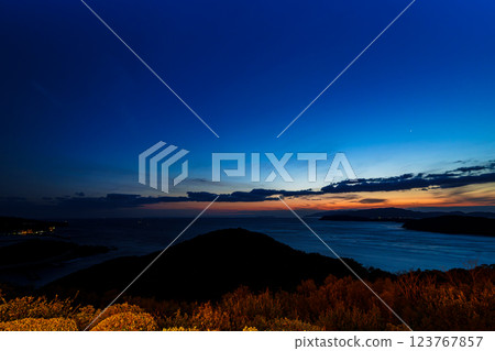 Early spring in the Kitan Straits. Ships passing by, clouds flowing, and a beautiful sunset. After sunset, the sky is glowing. Early spring in the Kitan Straits. Ships passing by, clouds flowing, and a beautiful sunset. After sunset, the sky is glowing. 123767857