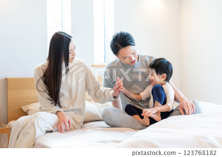 Young family having a conversation in the bedroom Young family having a conversation in the bedroom 123768182