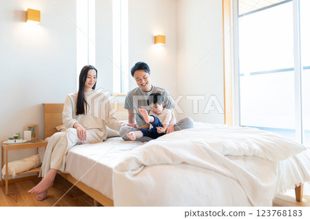 Young family having a conversation in the bedroom Young family having a conversation in the bedroom 123768183