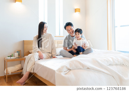 Young family having a conversation in the bedroom Young family having a conversation in the bedroom 123768186