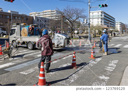 Workers doing road construction at an intersection 123769120
