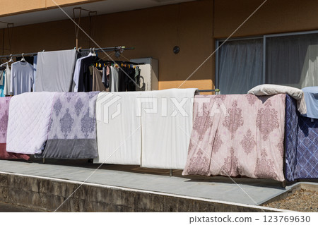 Hanging out futons and laundry on the balcony on sunny days 123769630