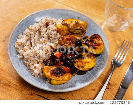 Boiled buckwheat in bowl with chicken legs. Dinner table, healthy food concept Boiled buckwheat in bowl with chicken legs. Dinner table, healthy food concept 123770246