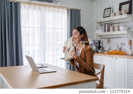 Young asian woman using computer laptop at home Young asian woman using computer laptop at home 123770324