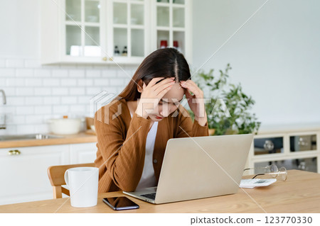 Office syndrome. Overworked tired young asian woman feeling headache Office syndrome. Overworked tired young asian woman feeling headache 123770330