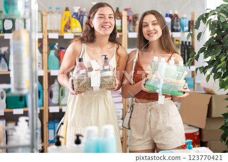 Two girls choosing gift basket in supermarket in summer Two girls choosing gift basket in supermarket in summer 123770421