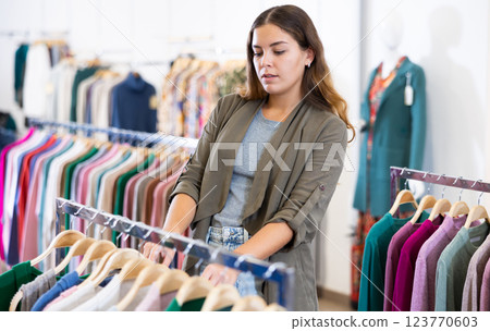 Young woman shopping casual clothes in store Young woman shopping casual clothes in store 123770603