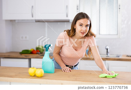 Portrait of female houseworker dusting kitchen surfaces 123770736