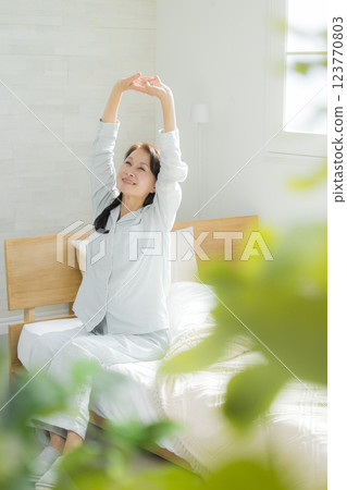 Senior woman stretching in bed 123770803
