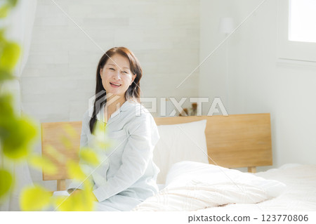 Senior woman stretching in bed 123770806
