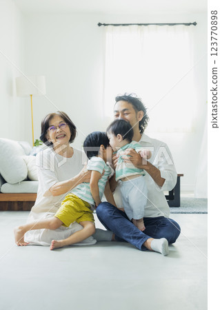 Three generations of family in the living room 123770898