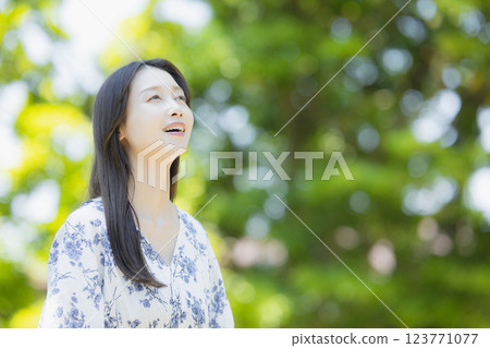 A woman in fresh green A woman in fresh green 123771077