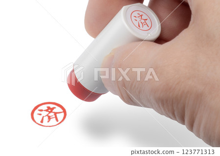 A hand stamping a completed seal A hand stamping a completed seal 123771313