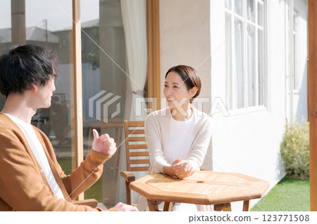 Man and woman relaxing on balcony 123771508