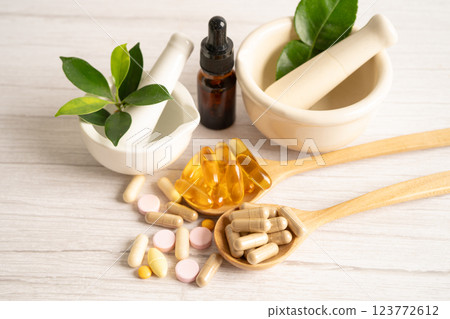 Alternative medicine herbal organic capsule with vitamin E omega 3 fish oil, mineral, drug with herbs leaf natural supplements for healthy good life. Alternative medicine herbal organic capsule with vitamin E omega 3 fish oil, mineral, drug with herbs leaf natural supplements for healthy good life. 123772612