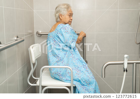Asian elderly woman patient use toilet bathroom handle security in nursing hospital, healthy strong medical. Asian elderly woman patient use toilet bathroom handle security in nursing hospital, healthy strong medical. 123772615