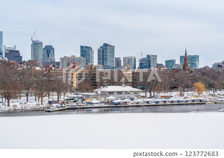 View of Boston skyline and skyscrapers in winter seen behind Charles River from Longfellow Bridge that covered in ice and snow 123772683