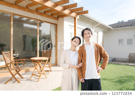 A couple standing in the garden of a lovely house 123772834