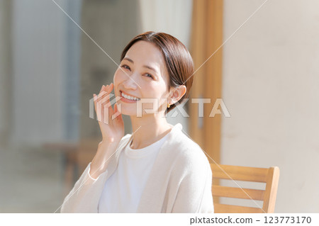 A woman in her 30s feels the moisture in her skin 123773170