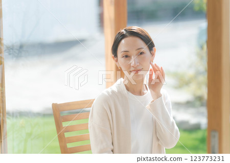 A woman in her 30s feels the moisture in her skin A woman in her 30s feels the moisture in her skin 123773231