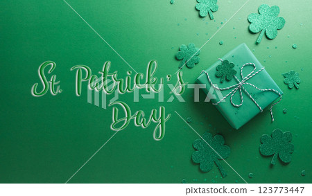 Happy St Patrick's Day decoration concept made from shamrocks ( clover leaf), gift box and leprechaun hat on green background. Happy St Patrick's Day decoration concept made from shamrocks ( clover leaf), gift box and leprechaun hat on green background. 123773447