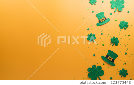 Happy St Patrick's Day decoration concept made from shamrocks ( clover leaf), wooden calendar and leprechaun hat on yellow background. 123773448