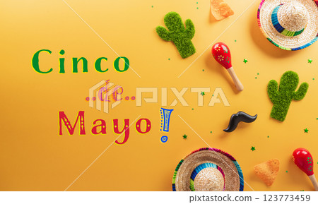 Cinco de Mayo holiday background made from maracas, cactus and hat on yellow background. Cinco de Mayo holiday background made from maracas, cactus and hat on yellow background. 123773459