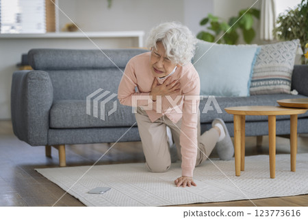 Senior woman collapses while holding her chest 123773616