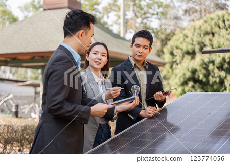 Innovative business teamwork. Professionals evaluating solar panel solutions together. 123774056