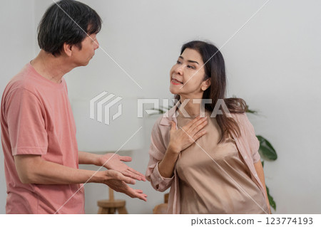 Diverse couple expressing emotions during a conversation in a cozy home office. Diverse couple expressing emotions during a conversation in a cozy home office. 123774193