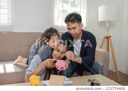 Family bonding over financial planning and savings activities with children Family bonding over financial planning and savings activities with children 123774468