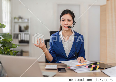 Accountant providing financial consultation via headset in a modern office. 123774470