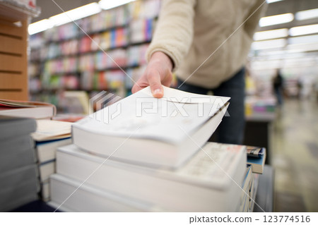 Customer's hands buying a book Customer's hands buying a book 123774516
