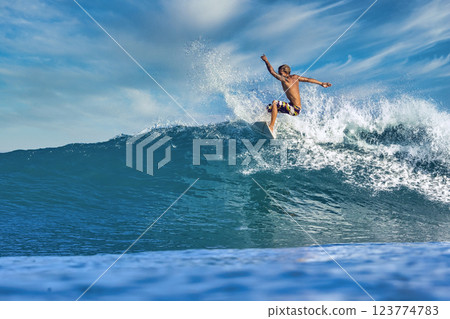 Male surfer on a blue wave Male surfer on a blue wave 123774783